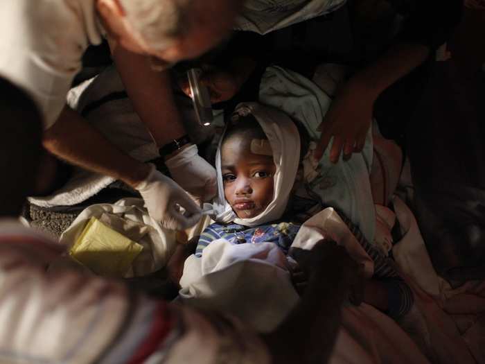 An injured child receives medical treatment after an earthquake in Port-au-Prince in this January 13, 2010 photo. The 7.0 magnitude quake rocked Haiti, killing thousands of people as it toppled the presidential palace and hillside shanties alike and leaving the poor Caribbean nation appealing for international help.