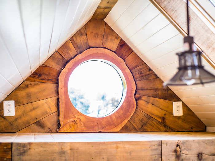 Their favorite feature in the home is the tree stump repurposed as window trim. Wood slats cut from an alligator juniper tree fan out like a sunburst.