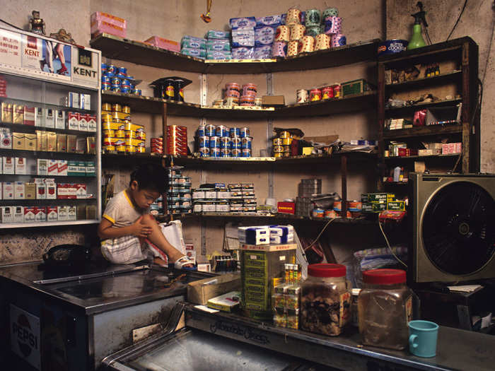 Often, commercial spaces like this grocery store would double as a living room or a space for the children to do homework after the working day was over.