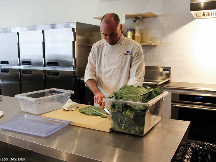 Betterment has a chef who cooks breakfast and lunch several times a week. Here chef Chris Ramos, formerly of Michelin-starred restaurant Per Se, prepares a collard-greens dish for the next day