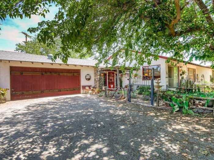 Western touches like wagon wheels and cacti dot the landscape of the house