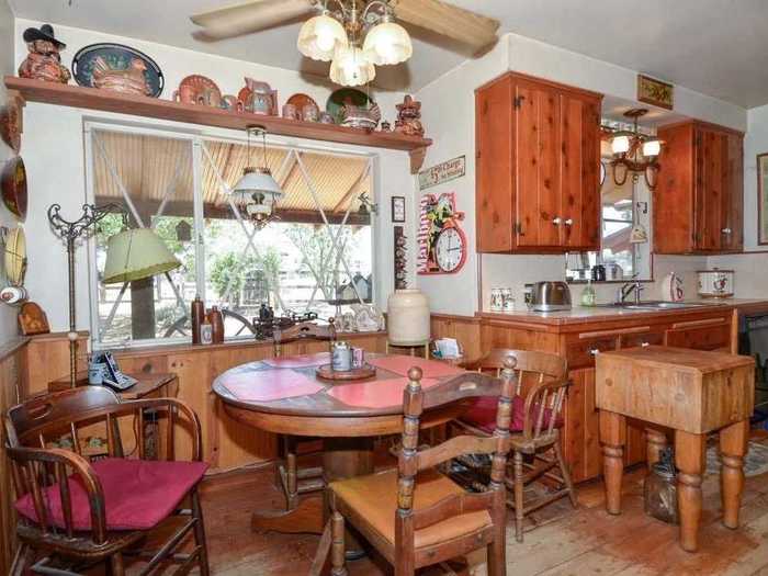 Antiques and and warm woods line the kitchen.