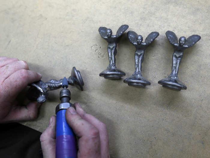 Once cooled, the Spirit of Ecstasy is completed by hand.