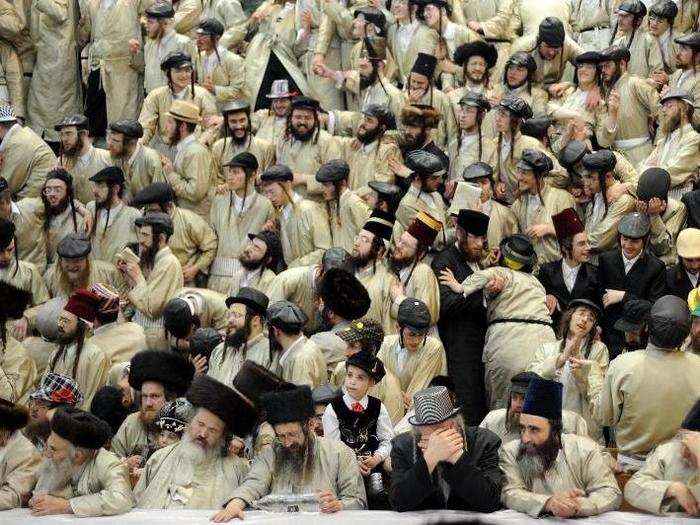 Ultra-orthodox Jewish men celebrate the Purim holiday in the Mea Shearim neighborhood of Jerusalem. The festival commemorates the rescue of Jews from genocide in ancient Persia.