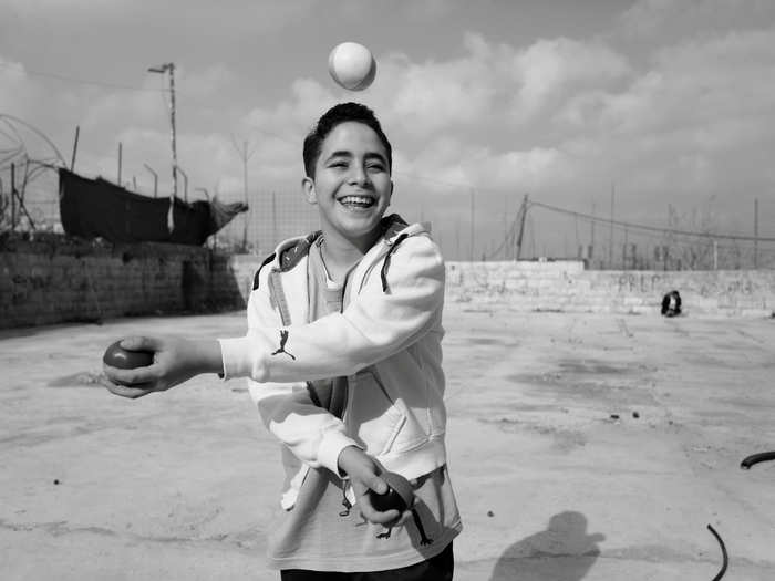 The Palestinian Circus School was established in 2009 in the village of Birzeit. Here, a Palestinian child practices at the school.