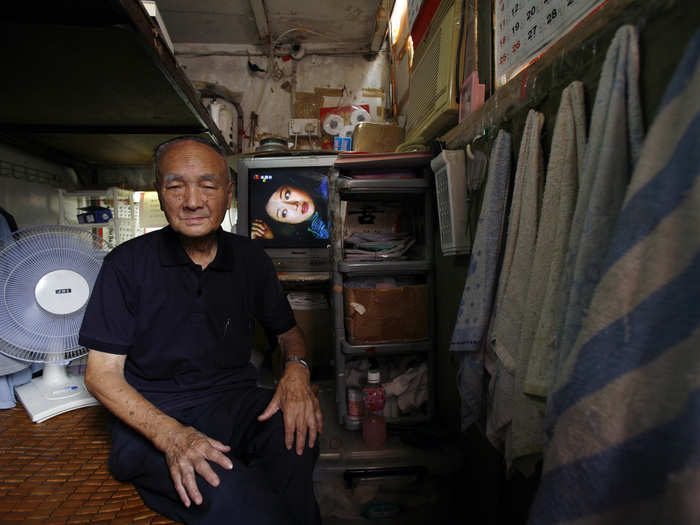 People can be forced into "cubicle" apartments, like the 24-square-feet unit Wong Chun-sing, 91, poses inside below. The Hong Kong government estimates that about 100,000 people live in similar units, which cost an average monthly rental rate of $150.