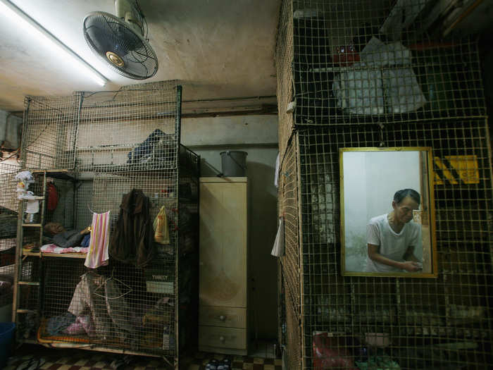 The lowest standard of living is the caged beds, which are stacked on top of each other. Each costs $150 a month to rent.