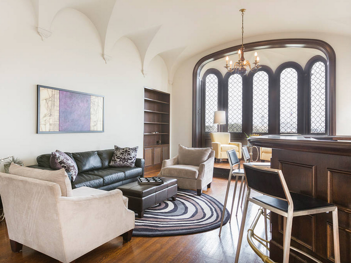 This living room, with a bar and large bay window, is perfect for party hosting.