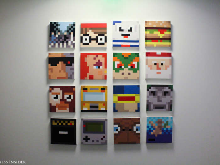 At the end of the hall, a gallery wall displays works of "bit art," or illustrations using large pixels of solid color to make recognizable figures. Marvel