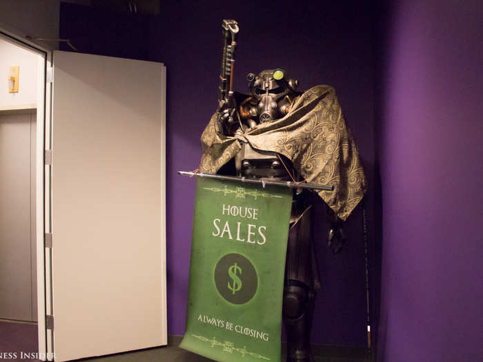 Around the corner, a character from the role-playing open-world game Fallout greets you with its laser rifle. The Sales team dressed it up in "Game of Thrones" garb for an office contest.
