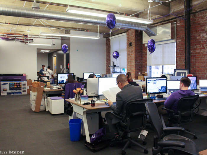 Every employee gets a purple hoodie on their first day. The purple balloons mark where the newbies sit.