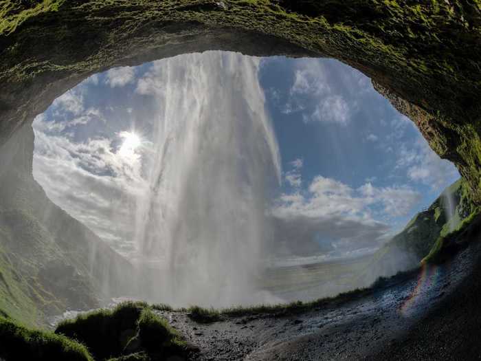 You can stand underneath the waterfall Seljalandsfoss.