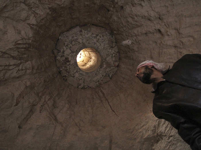 Those who do not have access to natural caves create underground shelters, often beneath their current homes. Here, a man is seen in a cave that is used as a shelter, under his house, in Kafruma, an area in the province of Idlib.