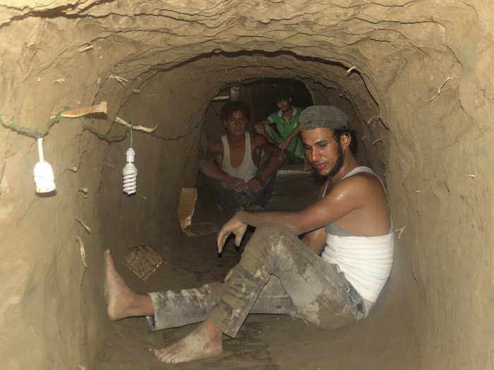 Others create spaces away from their homes. Here, residents dig tunnels and caves in mountains to be used as bomb shelters in Deir al-Zor, Syria.