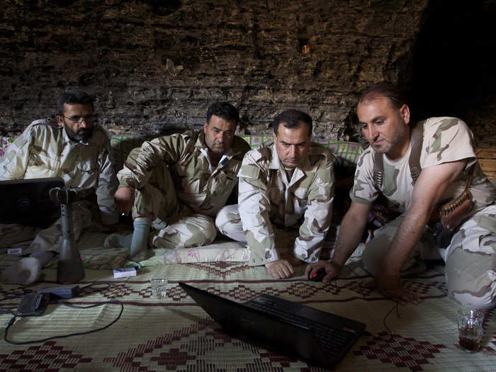 The caves are used by the rebels as meeting places for planning and communication. Here, Free Syrian Army fighters work on a computer inside a cave in Maaret al-Naaman, in Idlib.