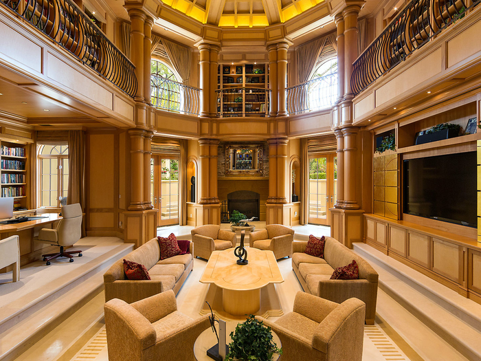 A two-floor library, complete with arched ceilings, columns, and a central reading library, is a luxurious place to do work.