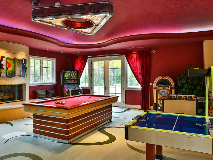 This home seems equipped for fun. This game room is stocked with some arcade favorites and a jukebox.