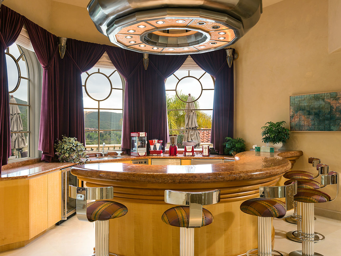 The theater includes a bar and popcorn makers.