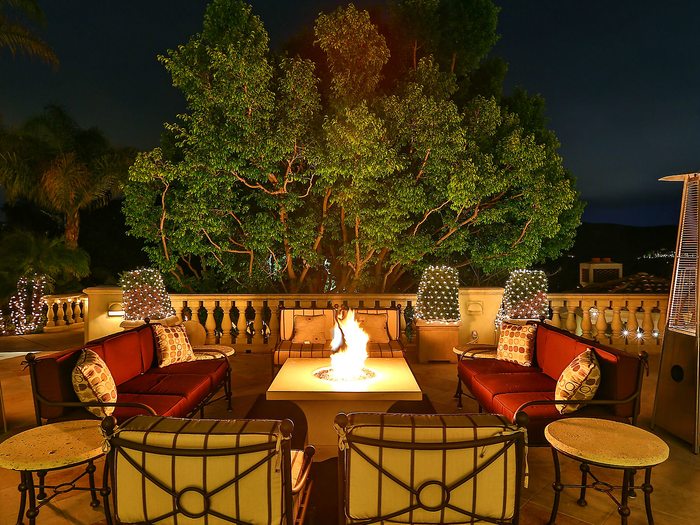 There are plenty of areas to enjoy the outdoors at night, like this outdoor area equipped with heat lamps and a fire pit.