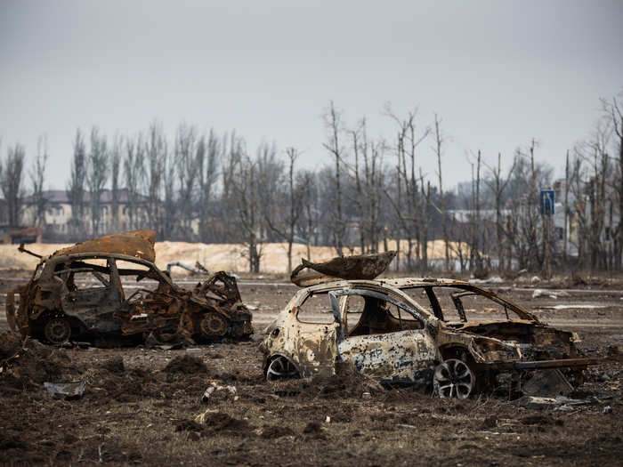 Gutted cars litter the area.