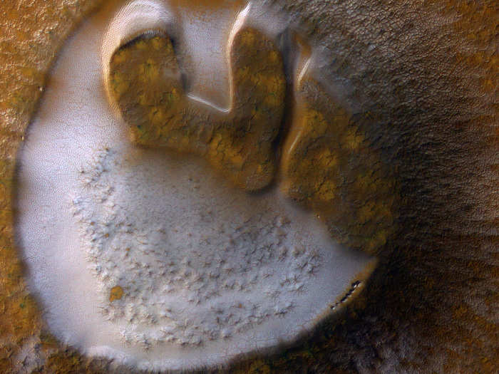 The polar caps on Mars contain frost shown here in white. But the frost isn