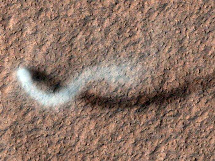 On one late-spring afternoon, the HiRISE camera snapped this picture of a towering dust devil in the Amazonia Planitia region on Mars. The plume is about 100 feet across and more than half a mile high!