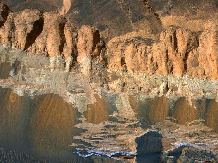 Near the equator on Mars is the Aram Chaos region and shown below is a very eroded portion of this area. The distinct strips of color indicate a change in the chemical properties of the rock.