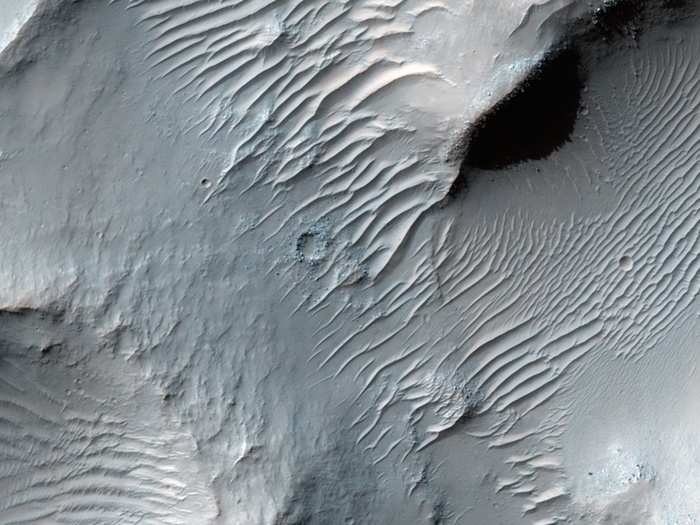 One of the longest ancient valleys on Mars is the Samara Valles, which is 621 miles long. Shown here is a heavily cratered portion of the valley. The craters show up  as circles that overlay the sand dunes.