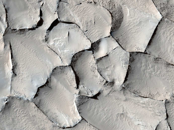 What created this jagged cracked surface in the Gordii Dorsum region on Mars is unknown. The rippled sand dunes suggest that these cracks were once large dunes themselves that then mysteriously hardened over time.