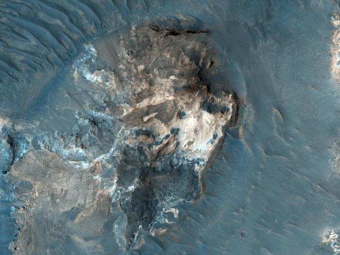 This is a part of a heavily cratered region on Mars called Aureum Chaos. The jagged terrain shows evidence of channels and erosion that scientists think formed from massive flooding in Mars