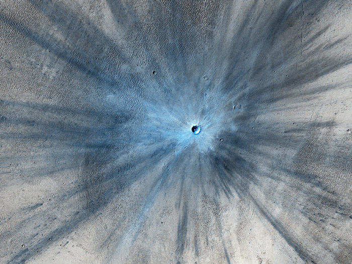 Researchers know that this crater is fresh because the dust it kicked up on impact is overlying the surrounding area. The crater itself is 100 feet wide while the long, dark streaks stretch as far away as 9.3 miles. Few impact craters on Mars have scars as dramatic as this one. The crater is not actaully blue, but falsely colored to highlight the impact ejecta.