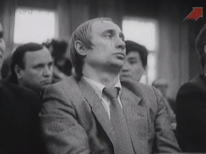 Undated footage of a longer-haired Vladimir Putin in Russia — Boris Yeltsin is out of shot to the right, suggesting the footage is from the early 1990s.