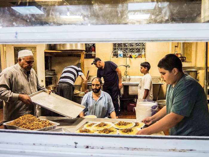 At many of the Islamic centers and mosques, men who have lived in the US for years help acclimate the newcomers by serving free meals at the end of each day.