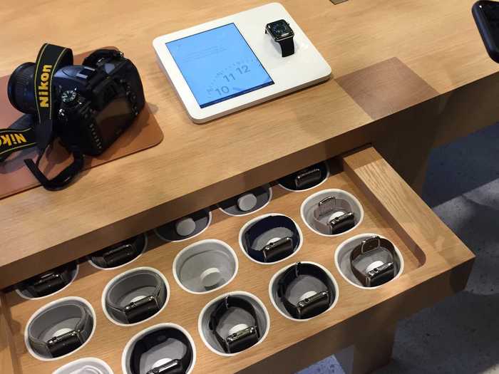 Apple employees undo a draw inside the store tables, where the Apple Watches are kept.