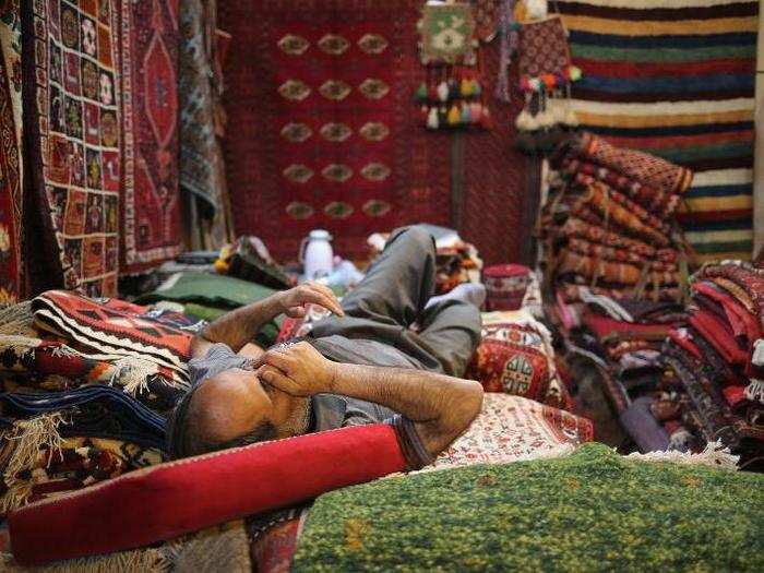 The Vakil Bazaar in Shiraz is one of the oldest and largest bazaars in Iran. It was first established in the 11th century. Here, a carpet vendor naps during his lunch break.