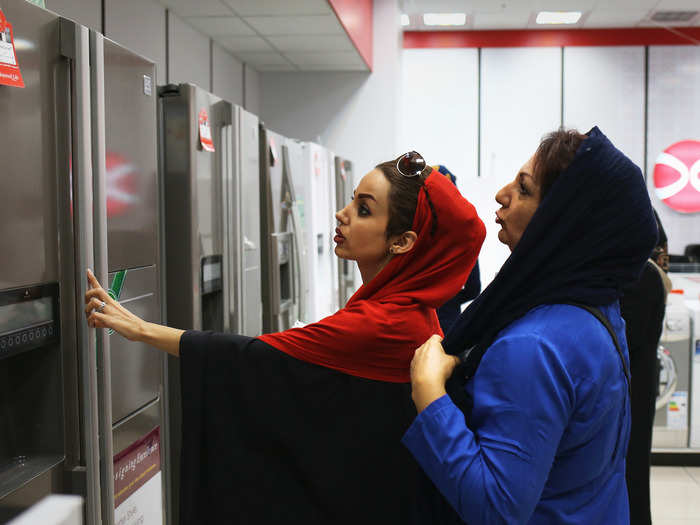 Moore says that one of the most surprising things about his trip was how — unlike other Islamic nations he has visited — the men and women were open to being photographed. Here, two women shop at the Daewoo appliance store.