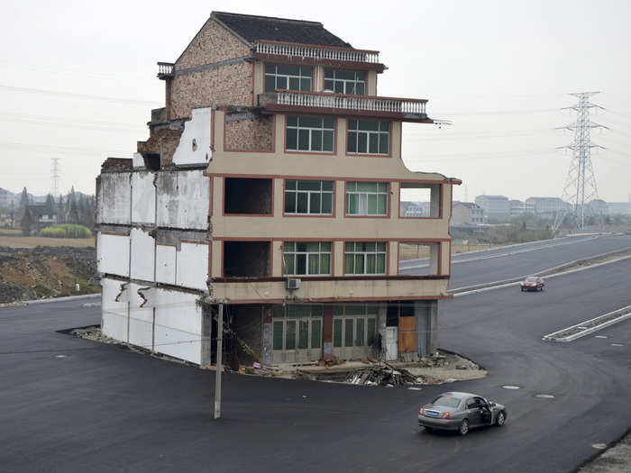 One of the most famous nail houses in China, this home in Wenling, Zhejiang province, belonged to an elderly couple that found their compensation offer inadequate. As a result, it stands in the middle of a road that was paved through their village.