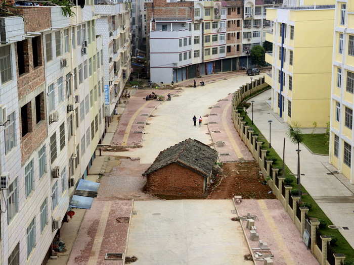 Another nail house in a road, the owner of this home in Nanning, Guangxi Zhuang Autonomous Region, reportedly failed to reach an agreement about compensation for demolition.