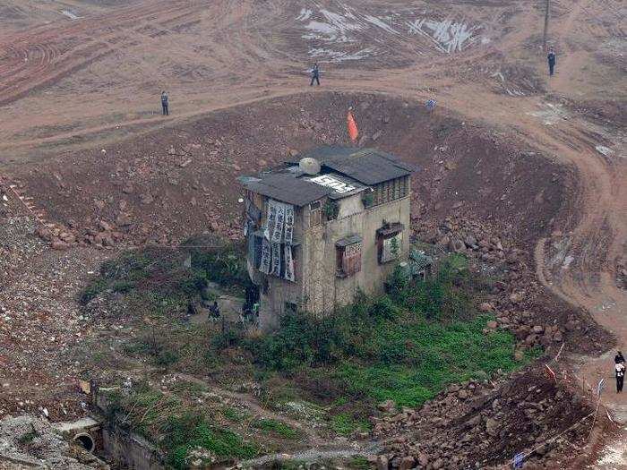 This nail house in Chongqing Municipality was the subject of debate in 2009, when the owners insisted on more compensation to allow the demolition of their home to make way for new apartment buildings.