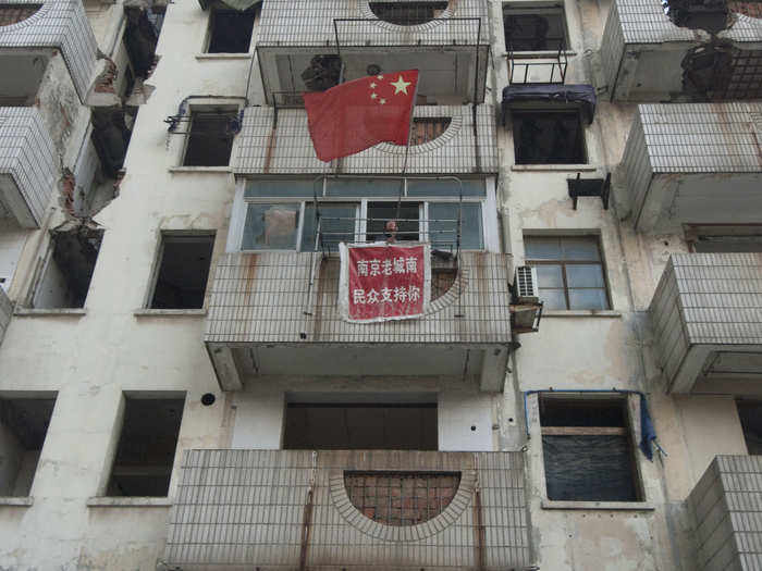 In 2010, the owner of this nail apartment in Nanjing refused to move even though demolition had already started on other rooms in the building. The banner, from supporters, says, "People from the old south district of Nanjing support you."