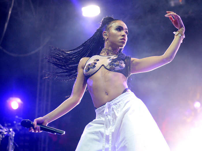 Singer-songwriter FKA Twigs whipped her hair back and forth as fiancé Robert Pattinson watched nearby.