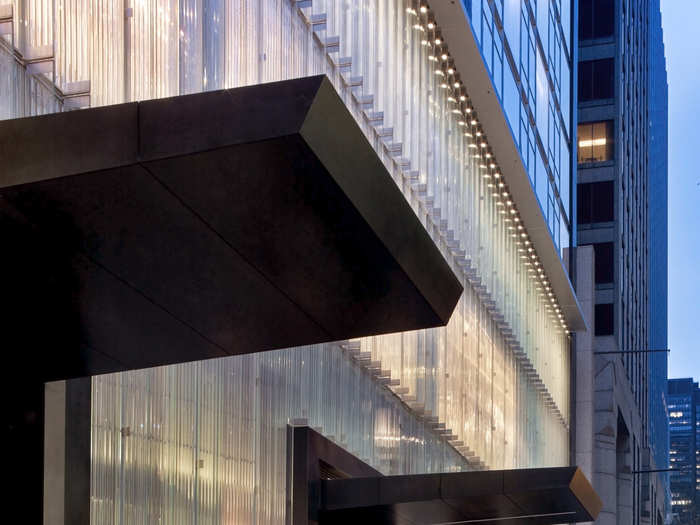 Guests enter past a set of electric fireplaces, veiled by a 125-foot-wide wall of corrugated crystal.