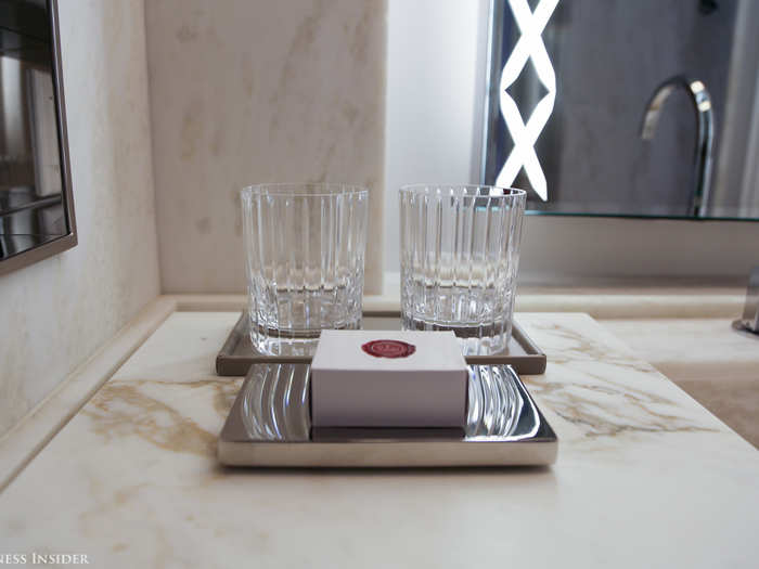 Even rinsing can feel luxurious. A set of two tumblers, valued at $270, rests on the bathroom counter.