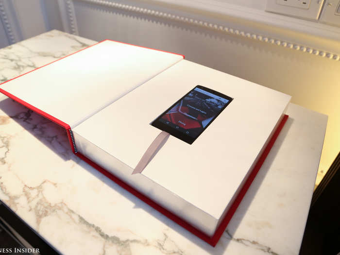 By the bed, a large plain book hides a Nexus smartphone that acts as the room