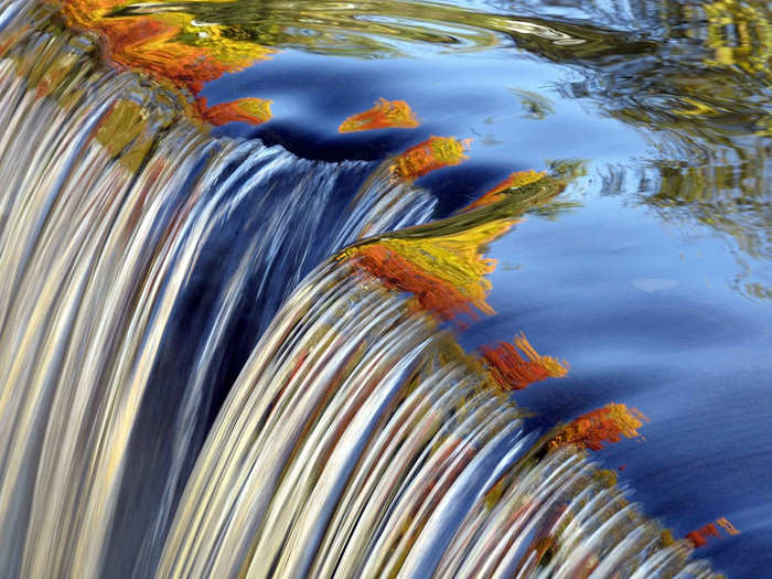 The colors of fall can be seen reflected in a waterfall along the Blackberry River in Connecticut.