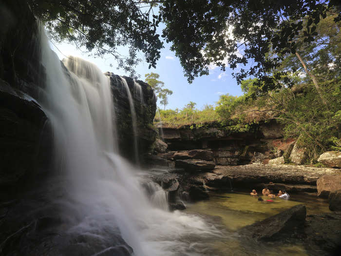 Tourists bathe at the El Cuarzo waterfall, locally referred to as the River of Five Colors, in Cano Cristales in the Colombia