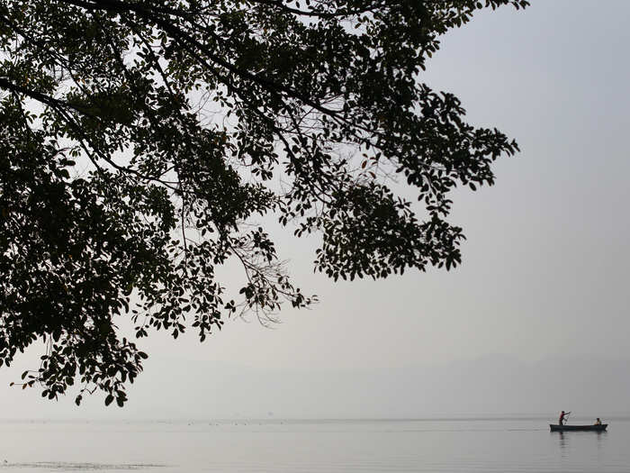 A local fisherman rows his boat across Lake Ilopango on the outskirts of San Salvador.