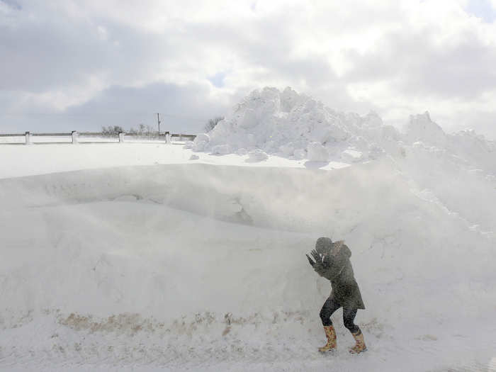 A person walks past a snowdrift in Northern Ireland.