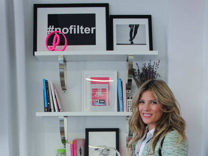 A set of shelves in one corner holds stylish photos, startup-themed books, and more internet-y decor.