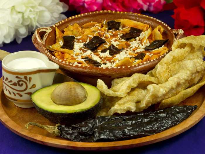 Sopa Azteca (tortilla soup) is a soup with a rich tomato base of pasilla chiles, crunchy corn tortillas, and oozing cheese. In Mexico, toasted chile pods are sometimes crushed over the top to give it an extra kick.